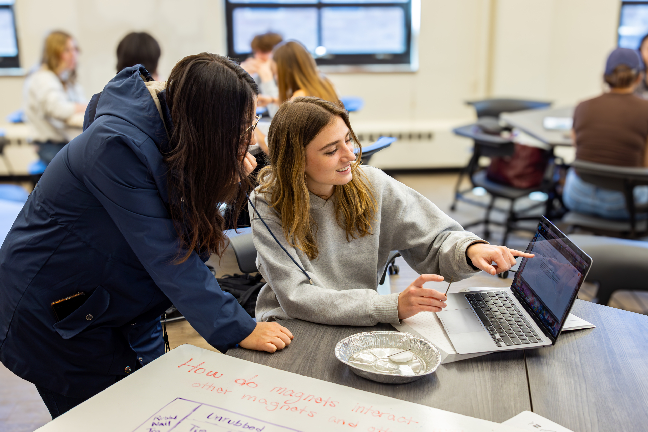 Students in a PEER Physics classroom collaborating during a lab activity